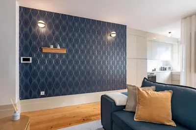 a living room with a blue couch and a wall at VIVA Formosa Flat in Porto