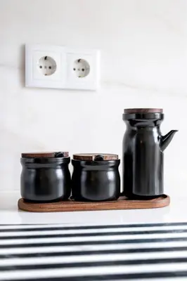 a shelf with three black pots on it at VIVA Formosa Flat in Porto