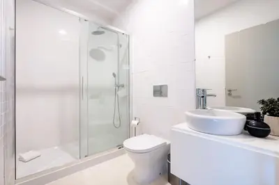 a bathroom with a shower and a toilet and a sink at VIVA Formosa Flat in Porto