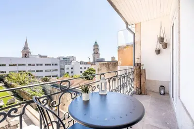 a blue table on a balcony with a view at VIVA Mosaics Studio in Porto