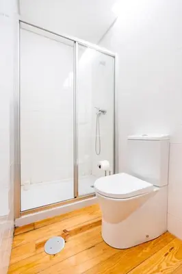 a white bathroom with a shower and a toilet at VIVA Mosaics Studio in Porto