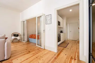 a living room with a hardwood floor and white walls at VIVA Liberty 310 in Porto