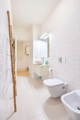 a white bathroom with a toilet and a sink at VIVA Liberty 310 in Porto