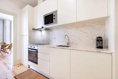 a white kitchen with a sink and a microwave at VIVA Liberty 310 in Porto