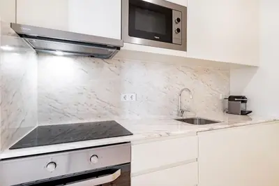 a white kitchen with a sink and a microwave at VIVA Liberty 310 in Porto