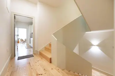 a white hallway with a staircase in a house at VIVA Liberty 310 in Porto