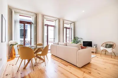 a living room with a white couch and a table at VIVA Liberty 310 in Porto