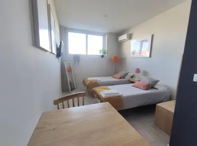 a living room with two beds and a table at Leote House - Studio 2 in Porto