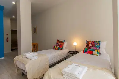 a living room with two beds and a table at Leote House - Studio 4 in Porto