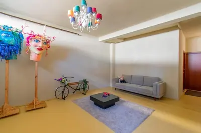 a living room with a couch and a chandelier at Leote House - Studio 4 in Porto
