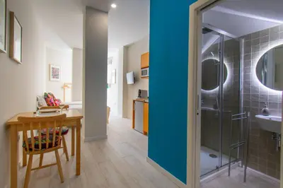 a bathroom with a shower and a table and a sink at Leote House - Studio 4 in Porto