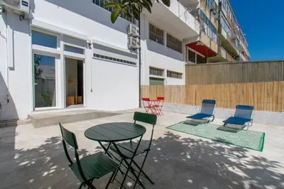 a patio with a table and chairs in front of a building at Leote House - Studio 4 in Porto