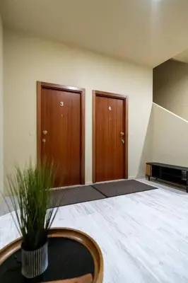 a room with two wooden doors and a potted plant at Leote House - Studio 4 in Porto