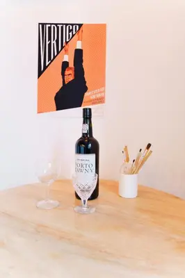 a bottle of wine and a glass on a table at The Loft 333 in Porto
