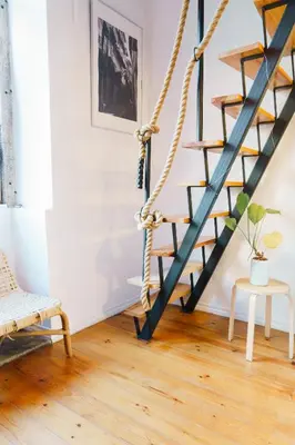 a black staircase in a living room with a wooden floor at The Loft 333 in Porto