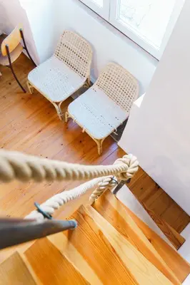two wicker chairs sitting on a hard wood floor at The Loft 333 in Porto