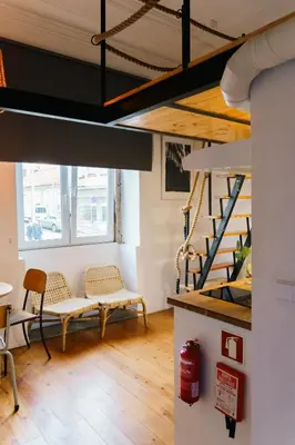 a room with two chairs and a staircase at The Loft 333 in Porto