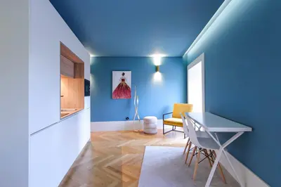 a blue room with a table and a chair at HM - Infante Riverside Apartment C in Porto