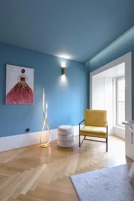 a living room with blue walls and a chair at HM - Infante Riverside Apartment C in Porto