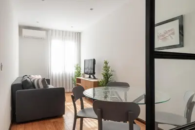 a living room with a glass table and chairs at Rivoli Apartments in Porto