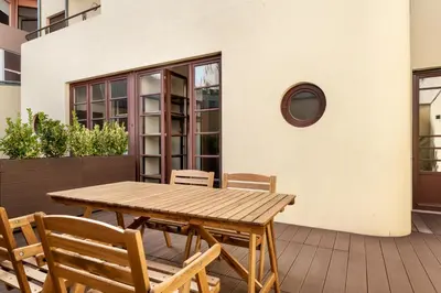 a wooden table and chairs on a patio at Rivoli Apartments in Porto