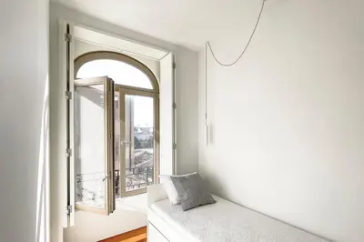 a white bathroom with a sink and a shower at Boavista 2-Bedroom Apartment in Porto