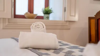 a towel sitting on top of a bed at Taipas Tranquility: Cozy T0 by LovelyStay in Porto