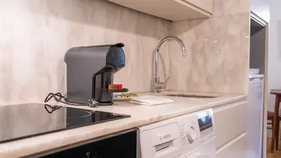 a kitchen with a coffee maker on the counter at Taipas Tranquility: Cozy T0 by LovelyStay in Porto