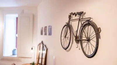 a bike hanging on a wall in a room at Taipas Tranquility: Cozy T0 by LovelyStay in Porto