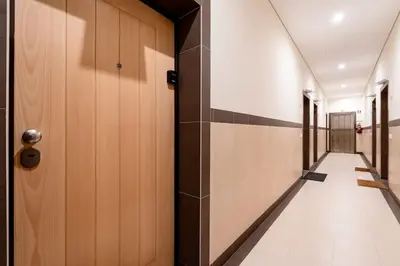 a hallway with wooden doors and a tile floor at VIVA Old Franciscan Studio in Porto