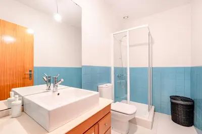 a bathroom with a white sink and a toilet at VIVA Old Franciscan Studio in Porto