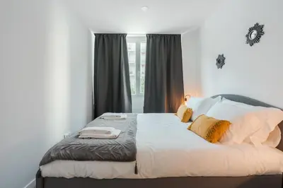 a bedroom with a large bed with yellow pillows at Great Location very Central Boavista in Porto