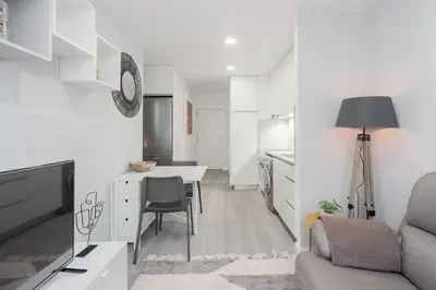 a kitchen and living room with a table and a couch at Great Location very Central Boavista in Porto