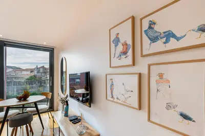 a living room with pictures on the wall at Fontainhas Royal in Porto