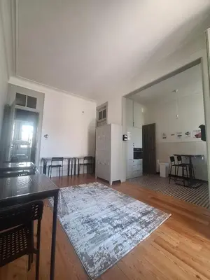 an empty living room with a table and a kitchen at Easy Host Porto in Porto
