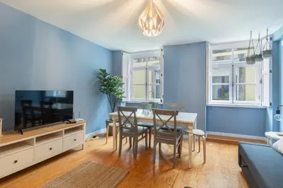 a dining room with blue walls and a table and chairs at GuestReady - Miragaia Blue in Porto