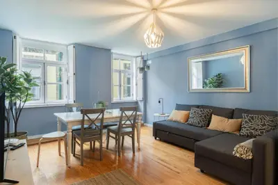 a living room with a couch and a table at GuestReady - Miragaia Blue in Porto