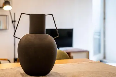 a black vase sitting on top of a table at The Priest's Home by LovelyStay in Porto