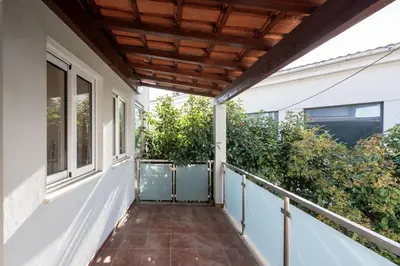 a balcony of a house with a wooden roof at GuestReady - Warm and Inviting flat with balcony in Porto