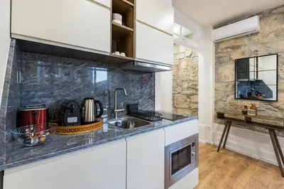 a kitchen with a sink and a counter top at GuestReady - Caldeireiros Studios in Porto