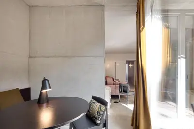 a dining area with a table and a living room at L'Olivier 23 - 2 apartments in a recently renovated Guesthouse in Porto