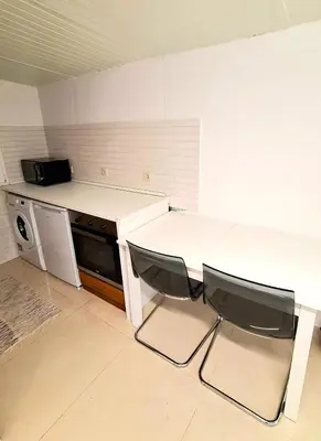 a kitchen with wooden cabinets and a sink at Bela Houses - Porto Center Garden - 3 in Porto