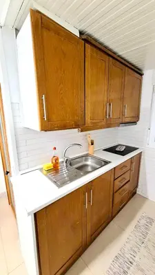 a small kitchen with a white table and chairs at Bela Houses - Porto Center Garden - 3 in Porto