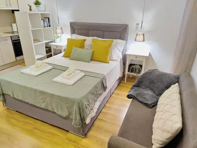 a small bedroom with a bed and a couch at Apartment in the historic center of Porto in Porto