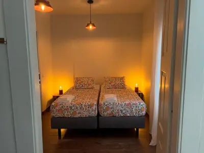 a white bathroom with a shower and a toilet at Casa da Maria Reguila in Porto