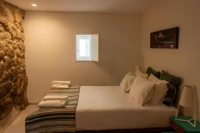 a bedroom with a bed and a window at ORM Santana Apartment in Porto