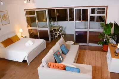 a living room with two white couches and a table at Travel & Live Marques Apartments in Porto