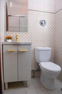 a bathroom with a toilet and a sink and a mirror at Travel & Live Marques Apartments in Porto