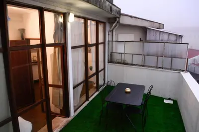 a small table on the balcony of a building at Travel & Live Marques Apartments in Porto