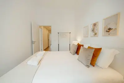a large white bed in a white room with pillows at Modern Bonfim by Hosty in Porto